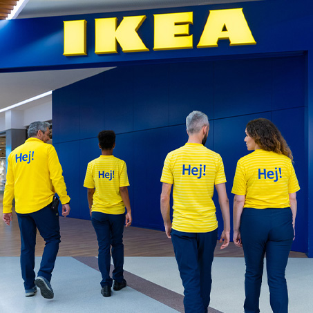 IKEA staff walk toward the store entrance.